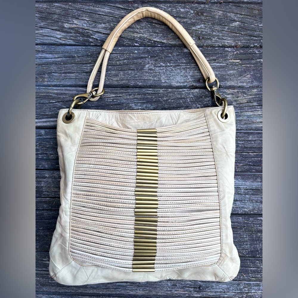 Stylish Cream Leather Shoulder Bag with Brass Accents
Like New